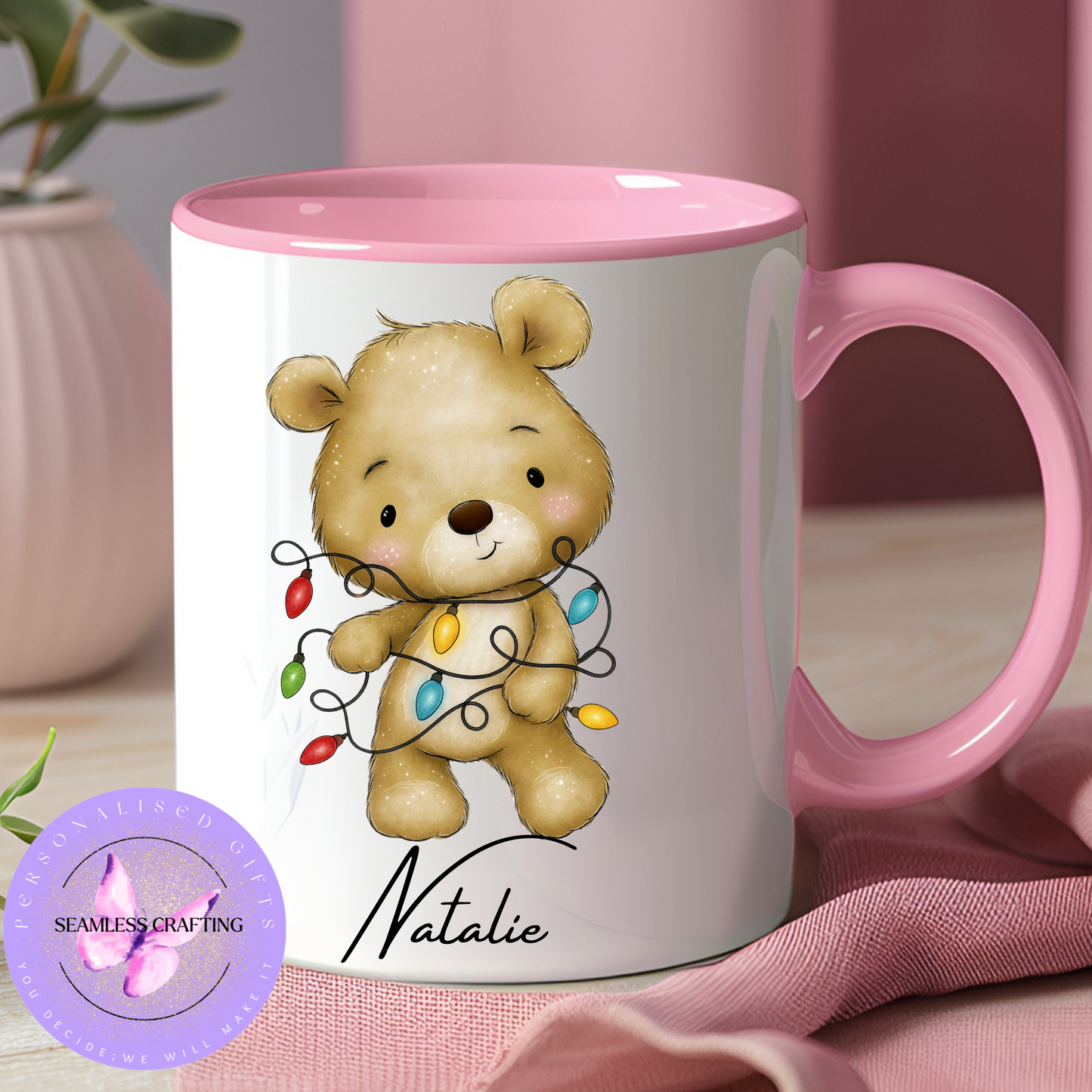 Mug with a teddy bear design and pink interior and handle, featuring the name 'Natalie'.