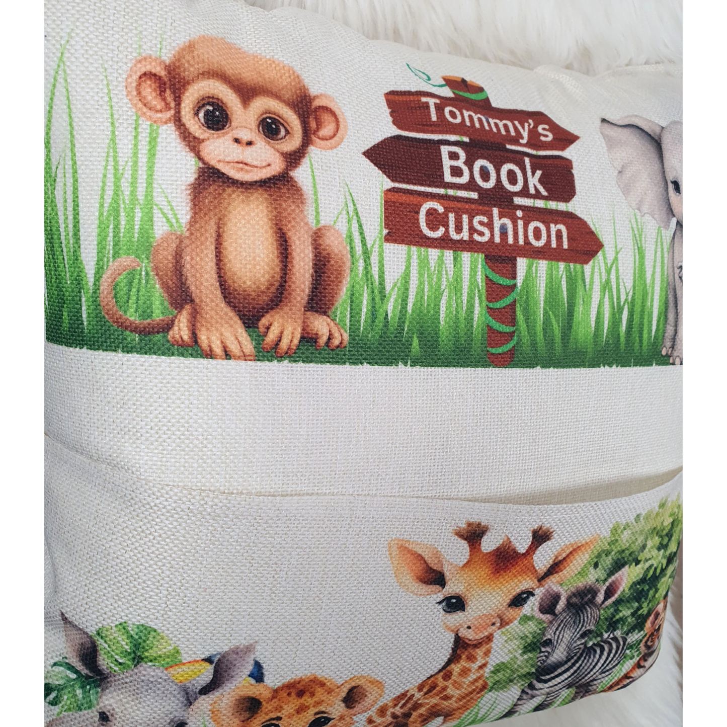 Personalised safari animal cushion for kids. Handmade linen book pocket pillow, perfect for jungle nursery decor or reading corner. Made in the UK.