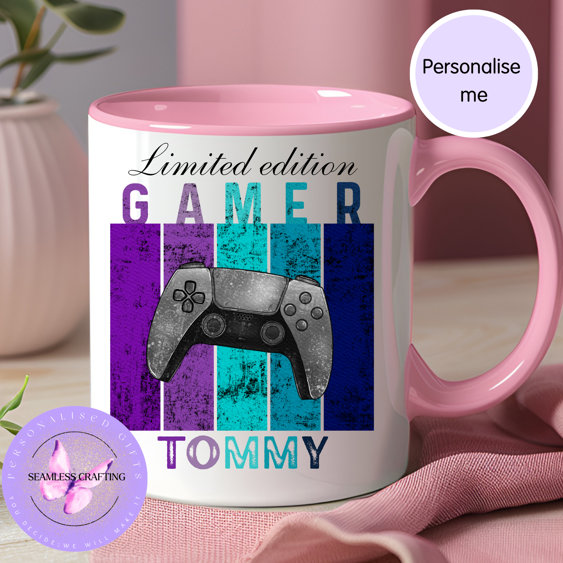 Mug with 'Gamer Tommy' design and pink handle on a pink surface.