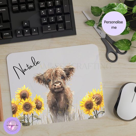 Personalised Highland cow mouse mat with sunflowers and name Natalie on office desk