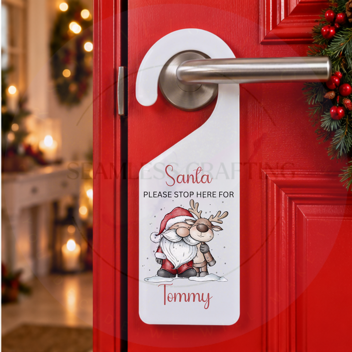 Personalised Santa Stop Here Christmas door hanger with custom name Tommy displayed on red door