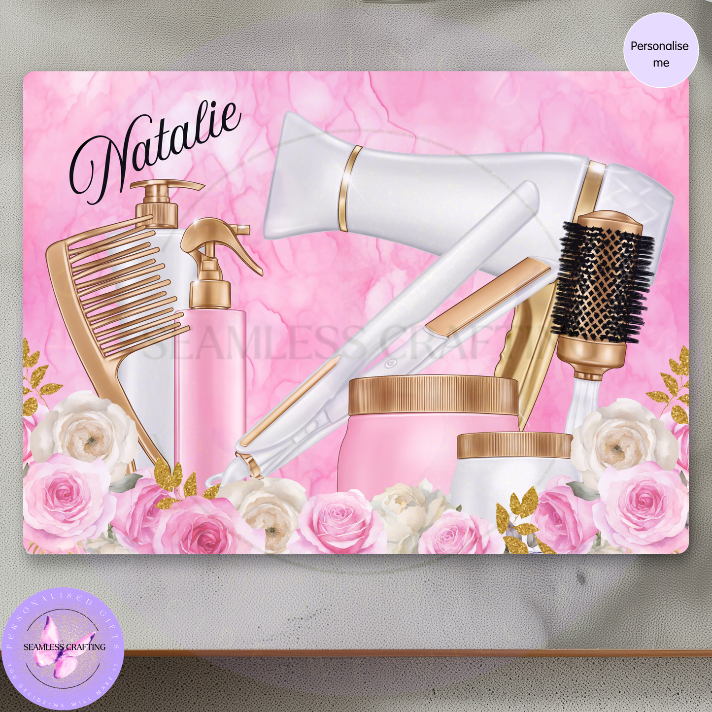 Personalised beauty glass worktop saver with pink marble background, hair styling tools and floral design.