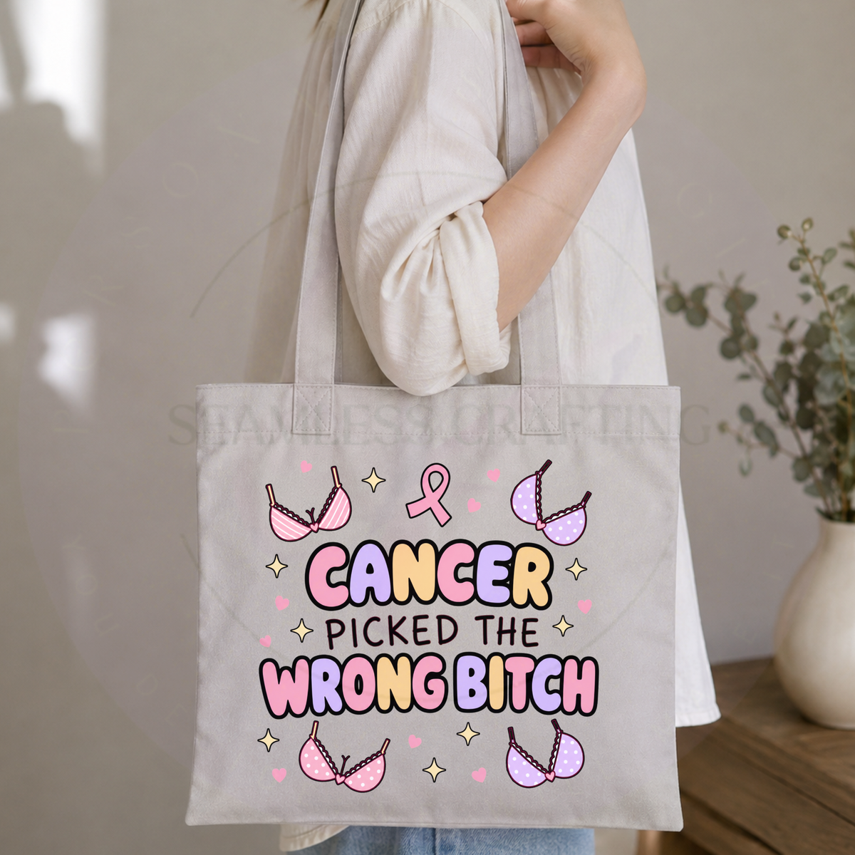 Woman carrying long-handle breast cancer survivor tote bag with colourful pink ribbon design