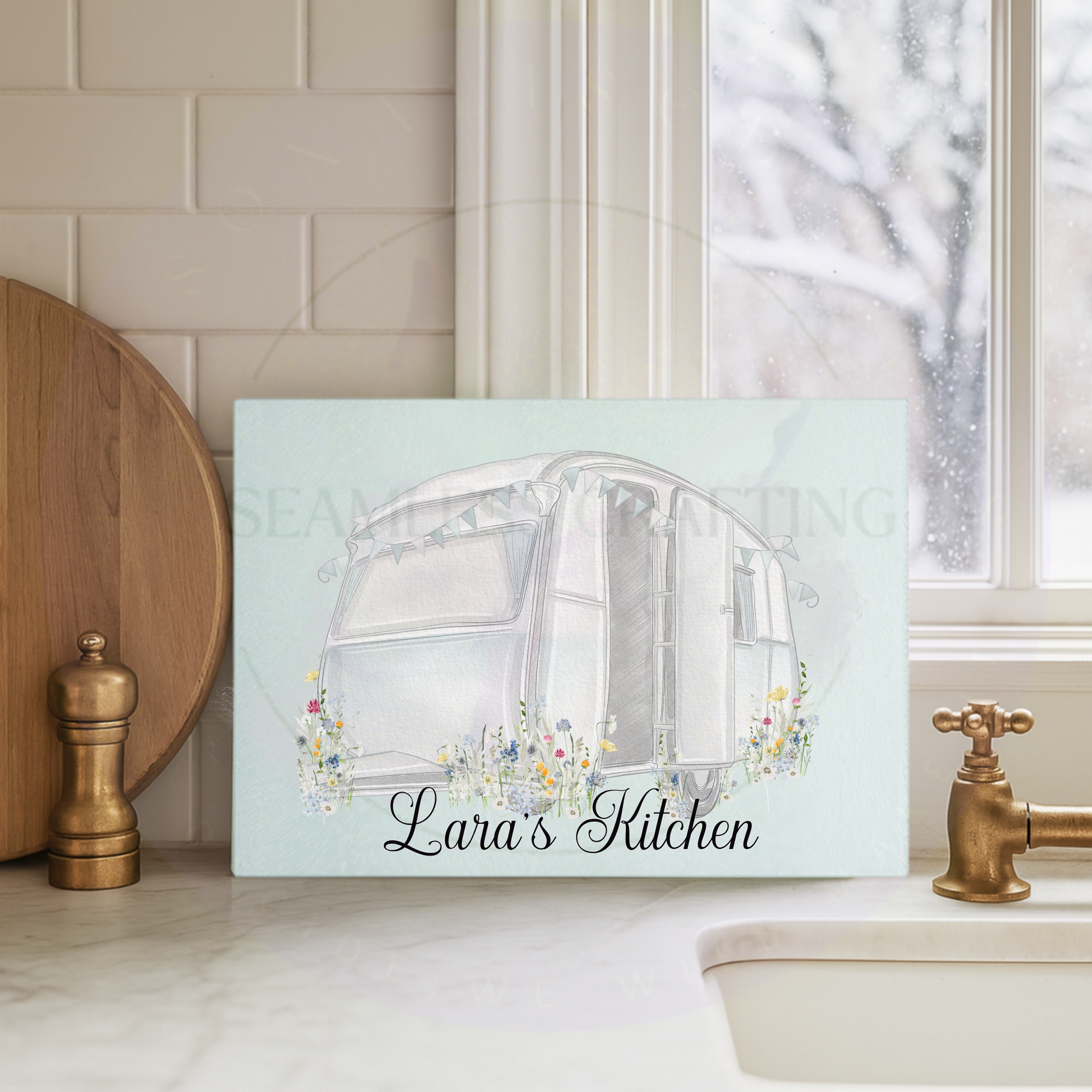 Custom name caravan chopping board with wildflower illustration on glass kitchen worktop surface