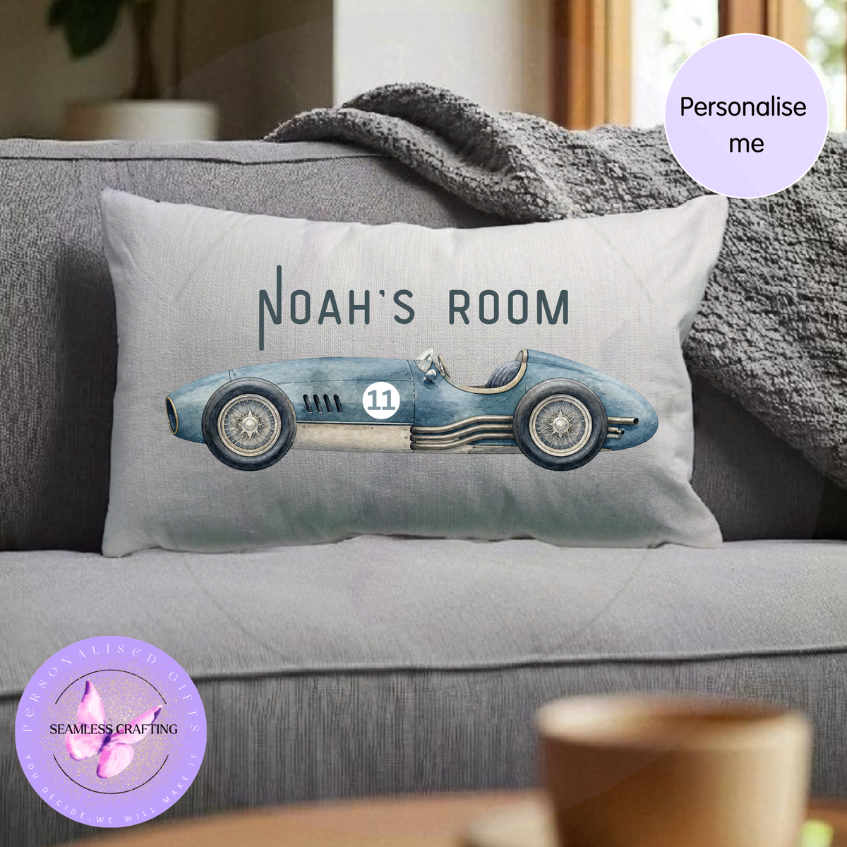 Personalised classic racing car cushion with custom Noah's Room wording displayed on grey sofa