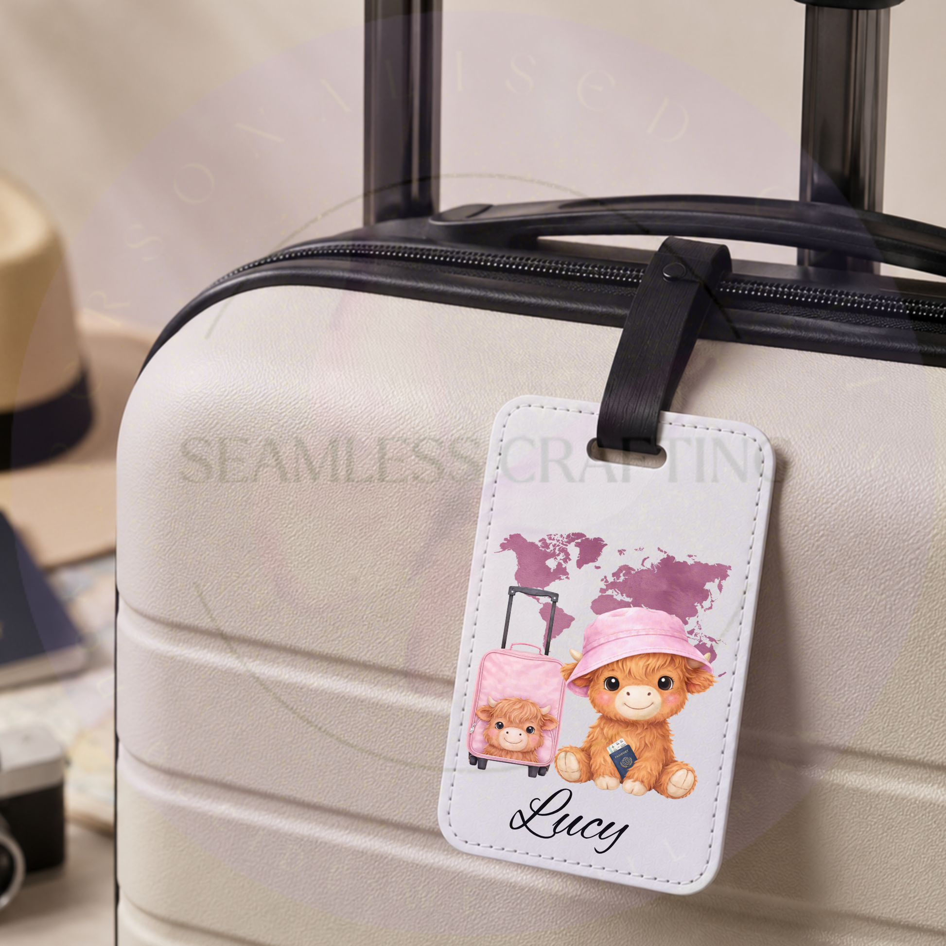 Personalised Highland cow luggage tag with Lucy attached to a white suitcase using a black fastening strap