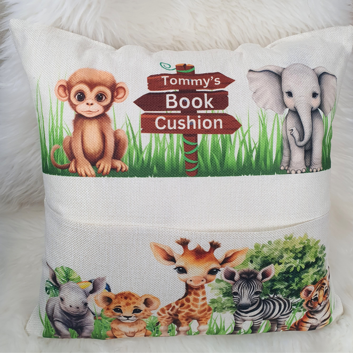 Personalised safari animal cushion for kids. Handmade linen book pocket pillow, perfect for jungle nursery decor or reading corner. Made in the UK.