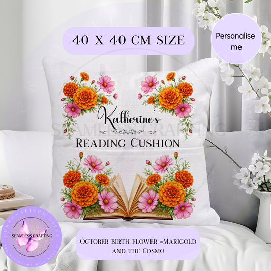 Personalised October birth flower reading cushion with orange marigolds, pink cosmos and open book design