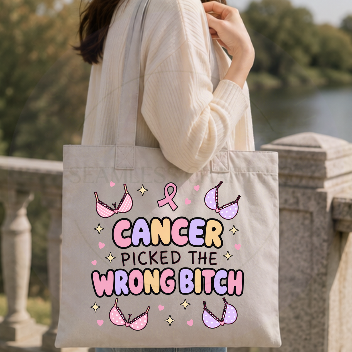 Breast cancer awareness tote bag with pink ribbon and illustrated bras carried outdoors