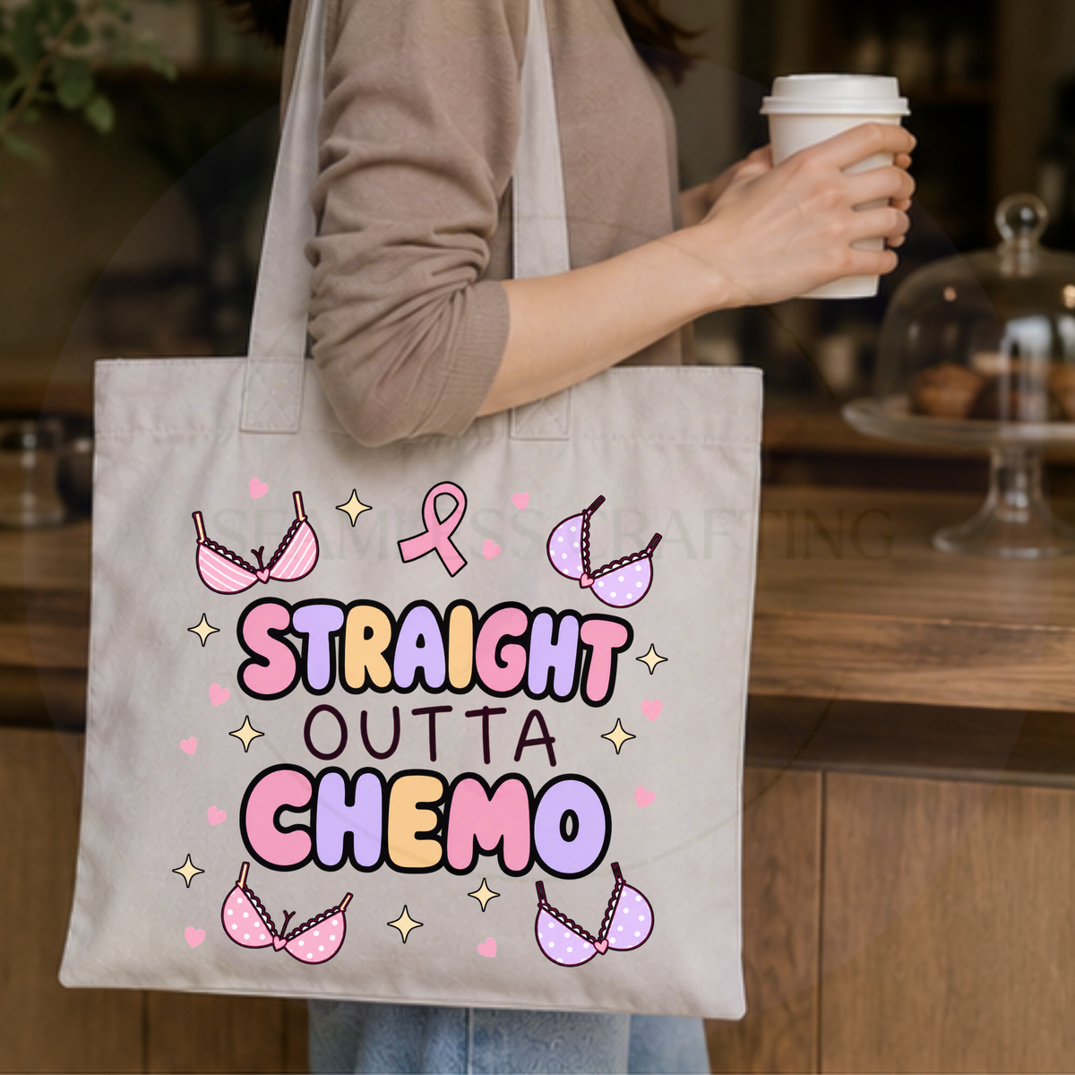 Woman holding coffee while carrying a Straight Outta Chemo tote bag in a café