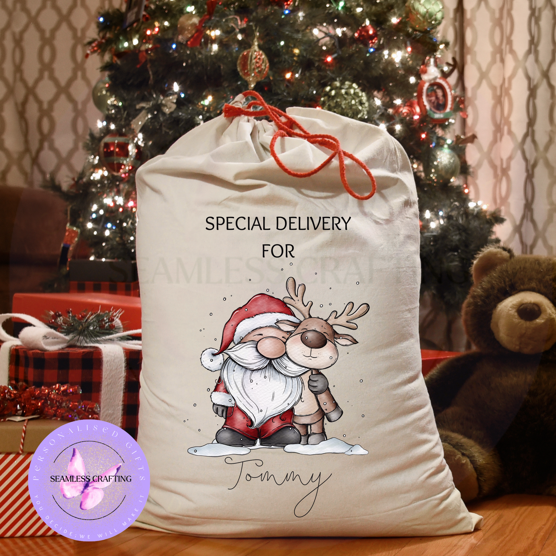 Large personalised Santa gnome and reindeer sack beside presents and teddy bear