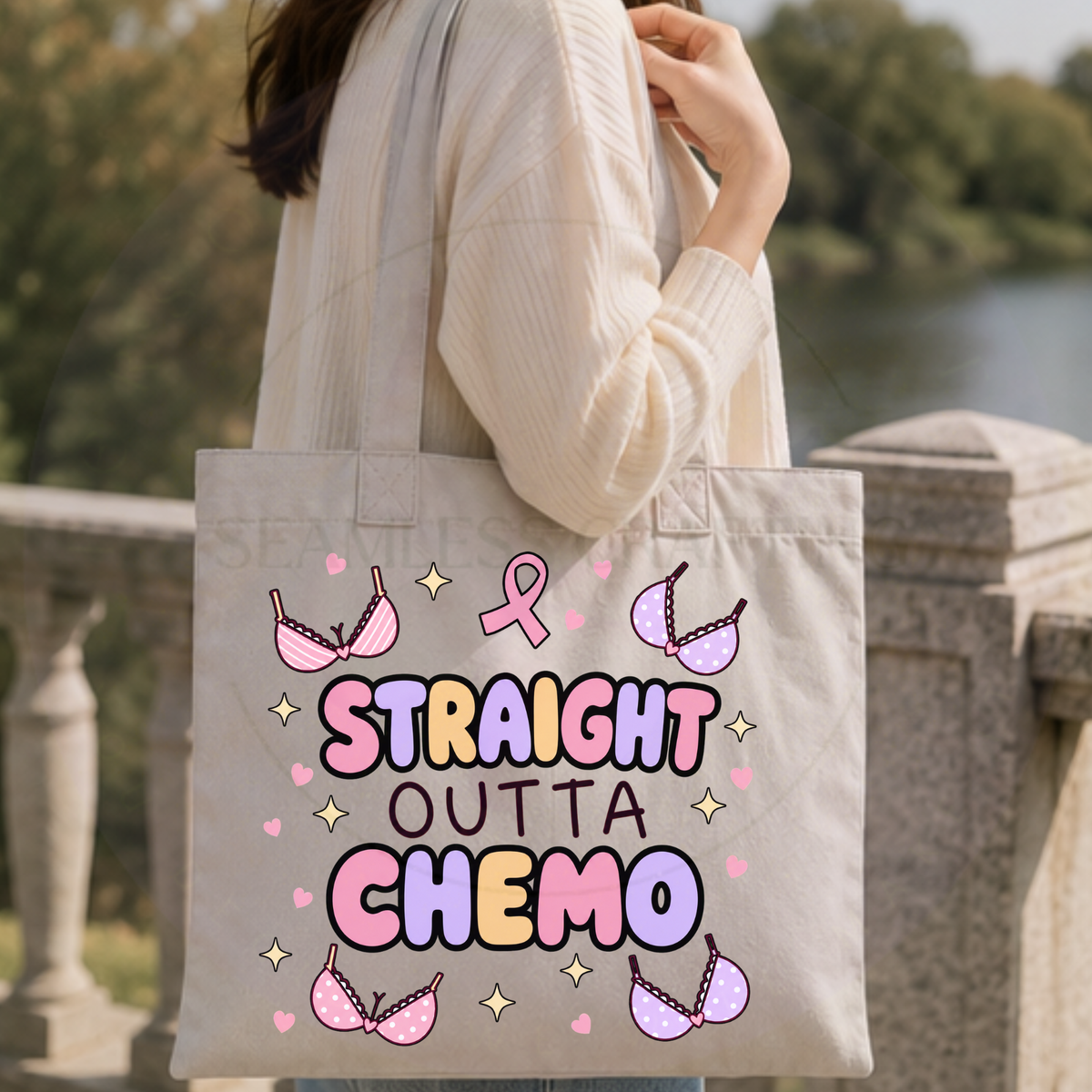 Woman carrying a Straight Outta Chemo tote bag outdoors beside a lake
