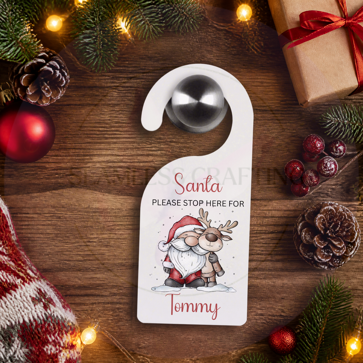 Personalised Santa Stop Here door hanger with custom name displayed with Christmas decorations