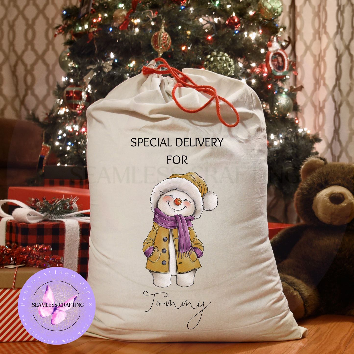 Personalised snowman Santa sack beside Christmas tree and presents