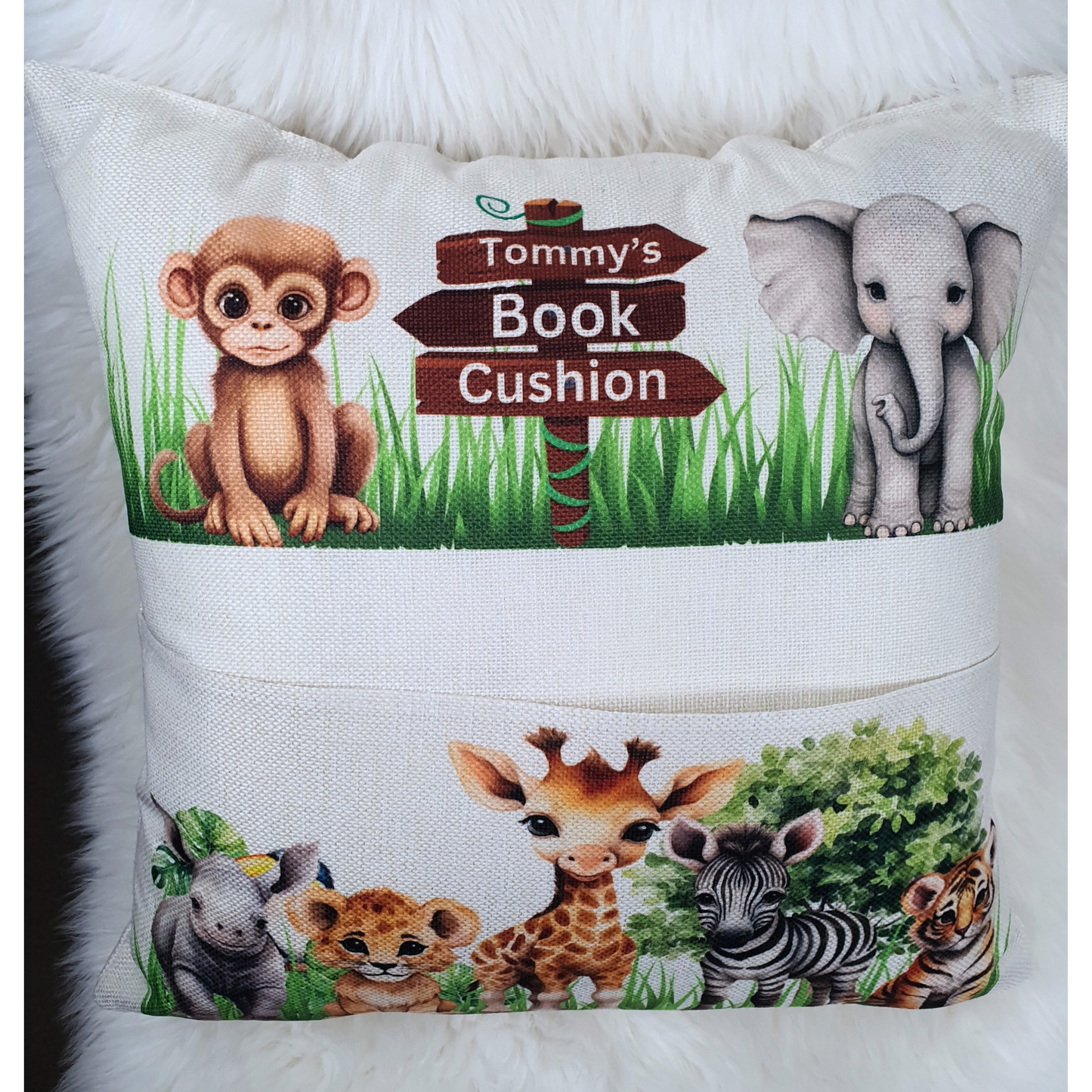 Personalised safari animal cushion for kids. Handmade linen book pocket pillow, perfect for jungle nursery decor or reading corner. Made in the UK.