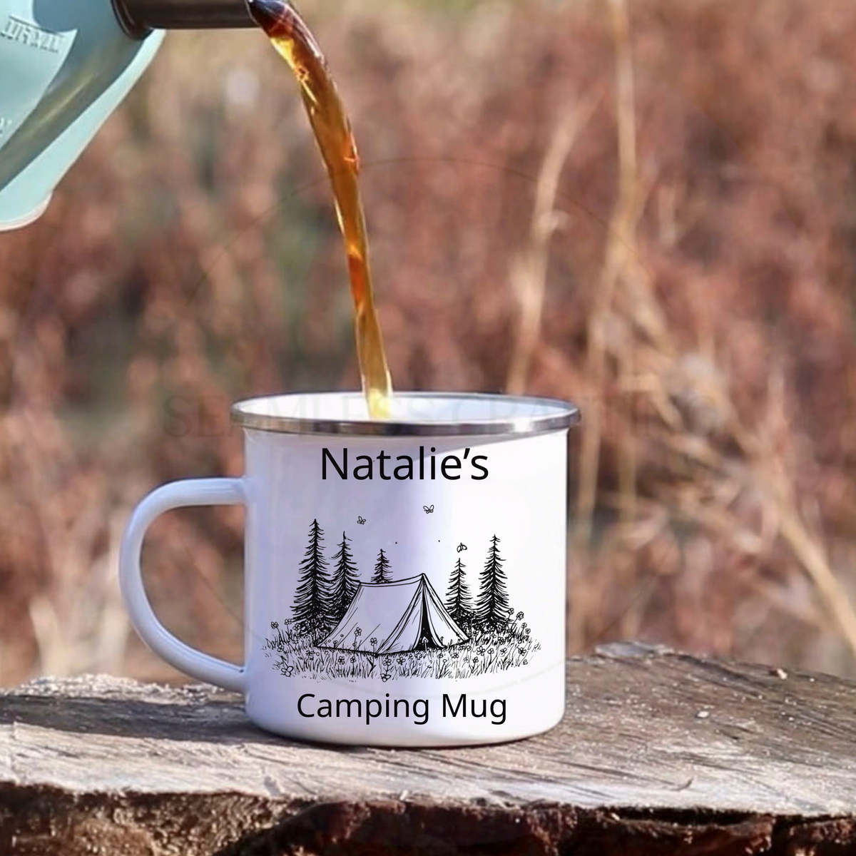 Hot drink being poured into personalised camping mug with tent and forest design outdoors