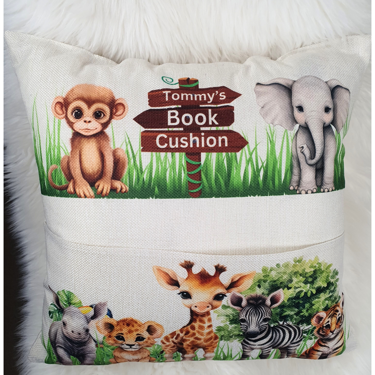 Personalised safari animal cushion for kids. Handmade linen book pocket pillow, perfect for jungle nursery decor or reading corner. Made in the UK.