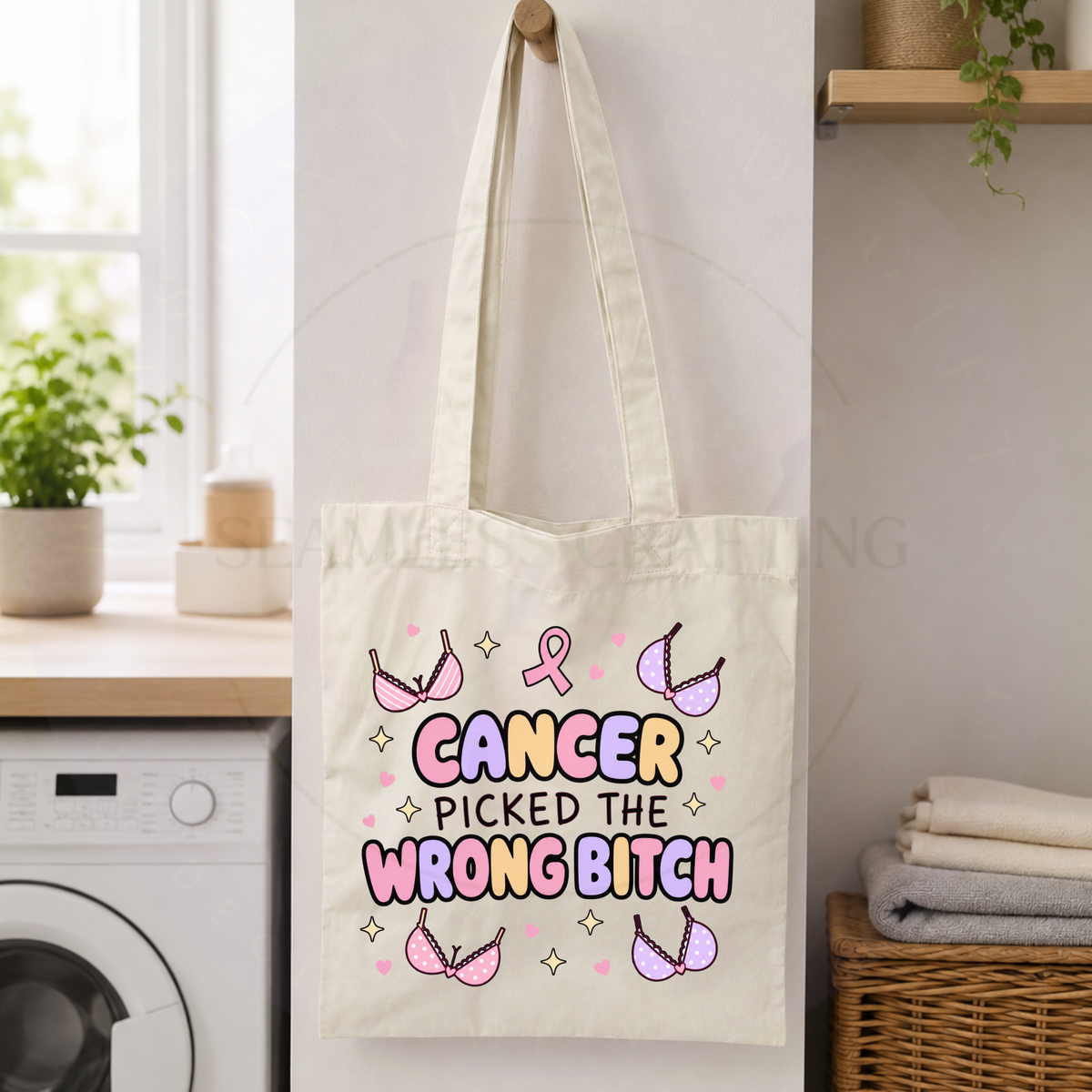 Long-handle breast cancer tote bag hanging beside a washing machine