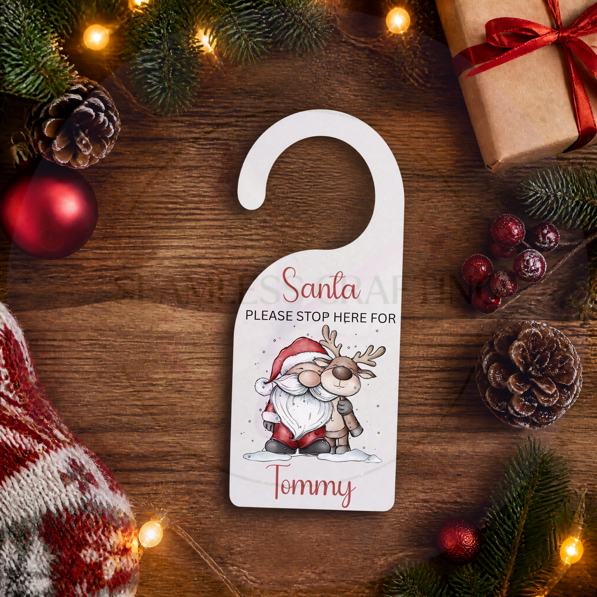 Personalised acrylic Santa door hanger with reindeer design and custom name Tommy on festive background