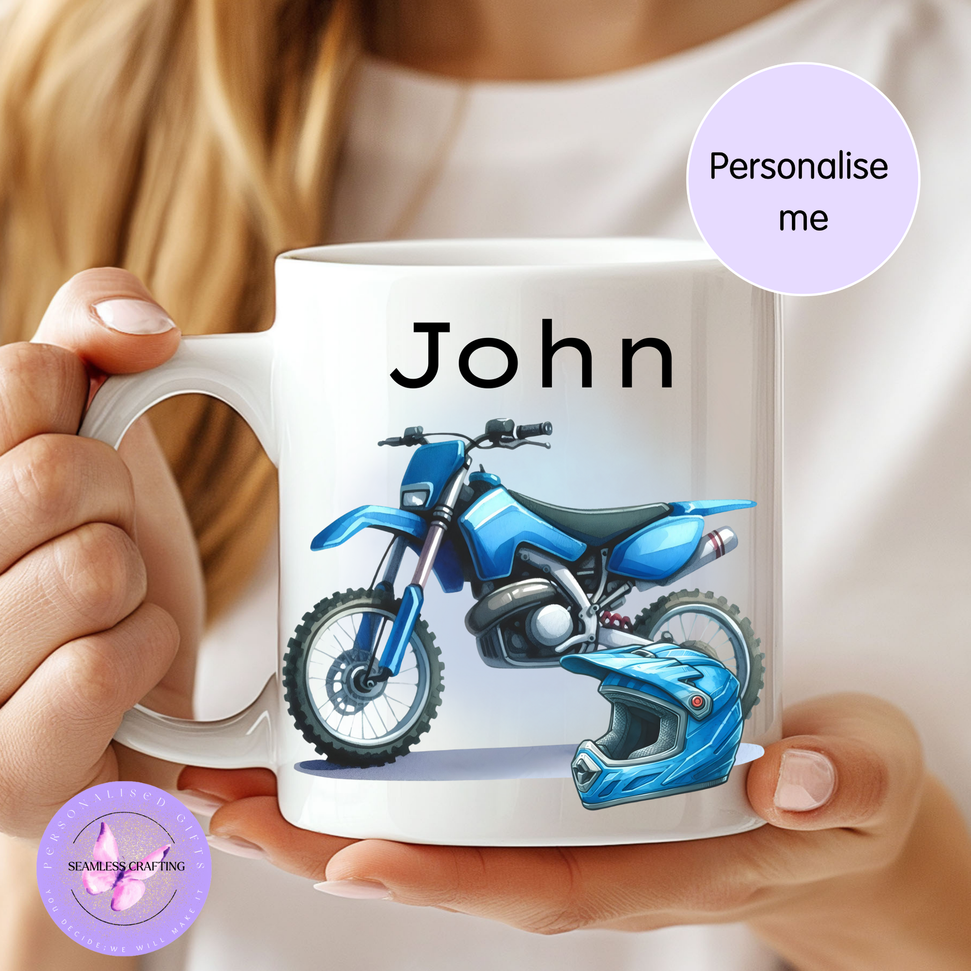 Person holding a mug with a blue motorcycle and helmet design, and the name 'John' printed on it.