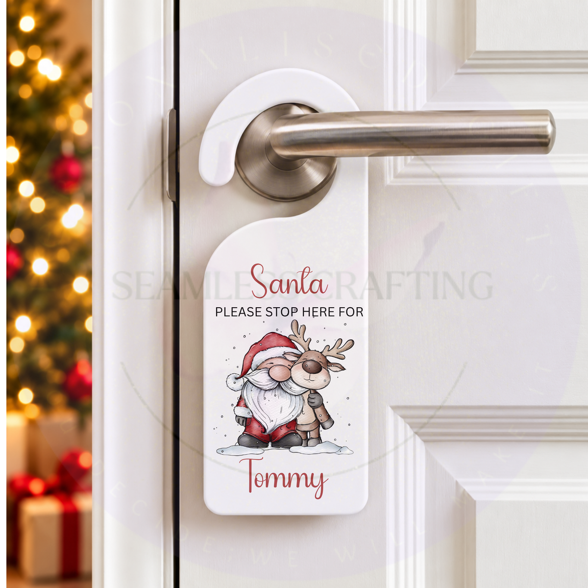Personalised Santa Stop Here Christmas door hanger on white door with festive tree and custom name Tommy