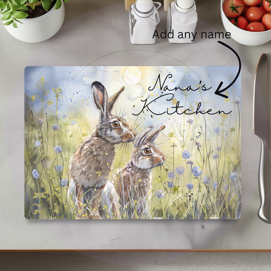 Personalised glass chopping board with spring hare design and custom name, decorative kitchen worktop saver gift
